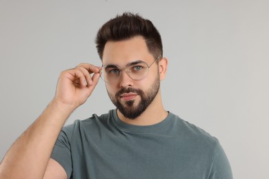 Photo of Handsome man wearing glasses on light gray background