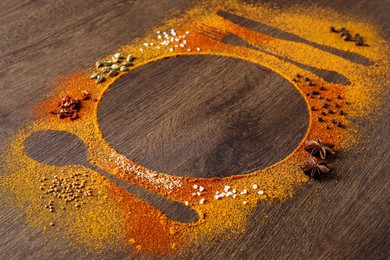 Photo of Silhouettes of cutlery and plate made with spices on wooden table, space for text