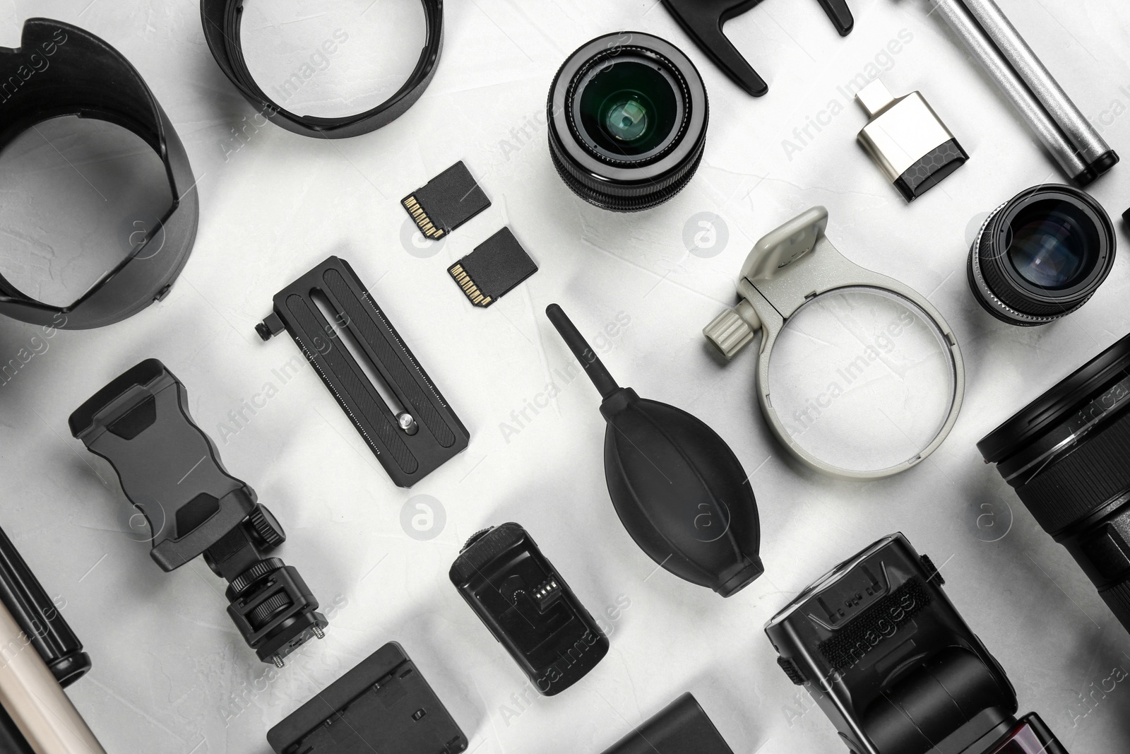 Photo of Flat lay composition with camera lens and video production equipment on light table