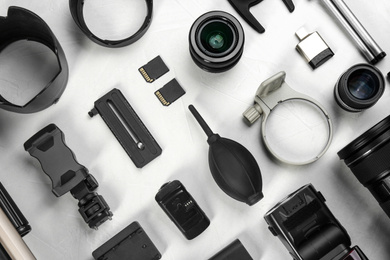 Flat lay composition with camera lens and video production equipment on light table