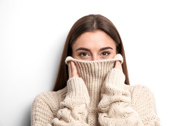 Photo of Beautiful young woman in warm sweater on white background