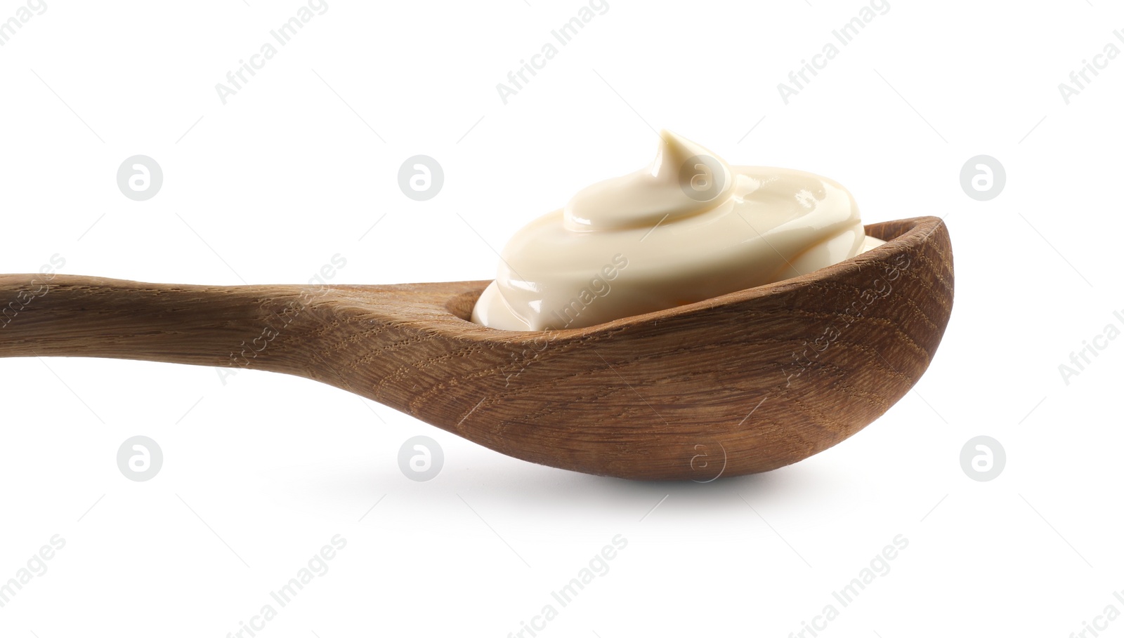 Photo of Natural yogurt in wooden spoon isolated on white