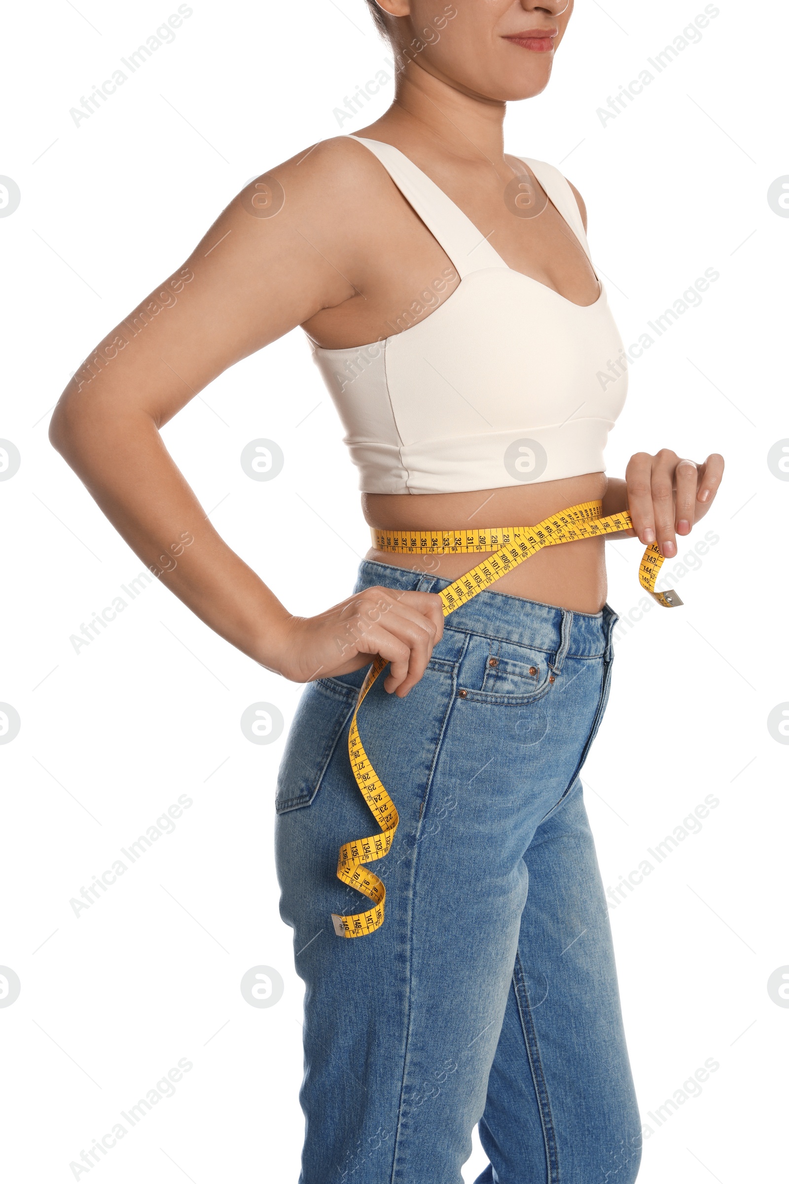 Photo of Woman measuring waist with tape on white background, closeup