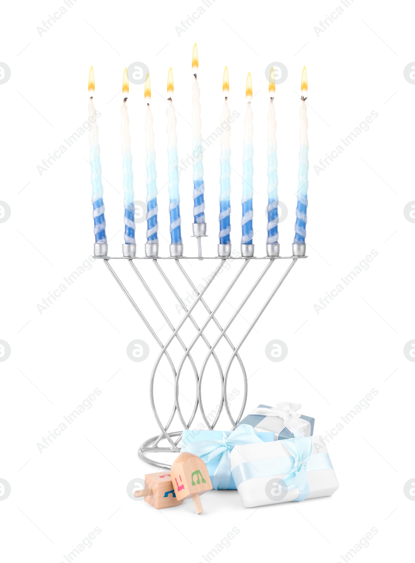 Photo of Hanukkah celebration. Menorah with candles, gift boxes and wooden dreidels isolated on white