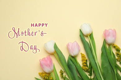 Image of Flat lay composition with beautiful spring flowers and phrase HAPPY MOTHER'S DAY on light yellow background