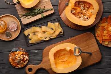 Flat lay composition with cut fresh ripe pumpkin on grey wooden table