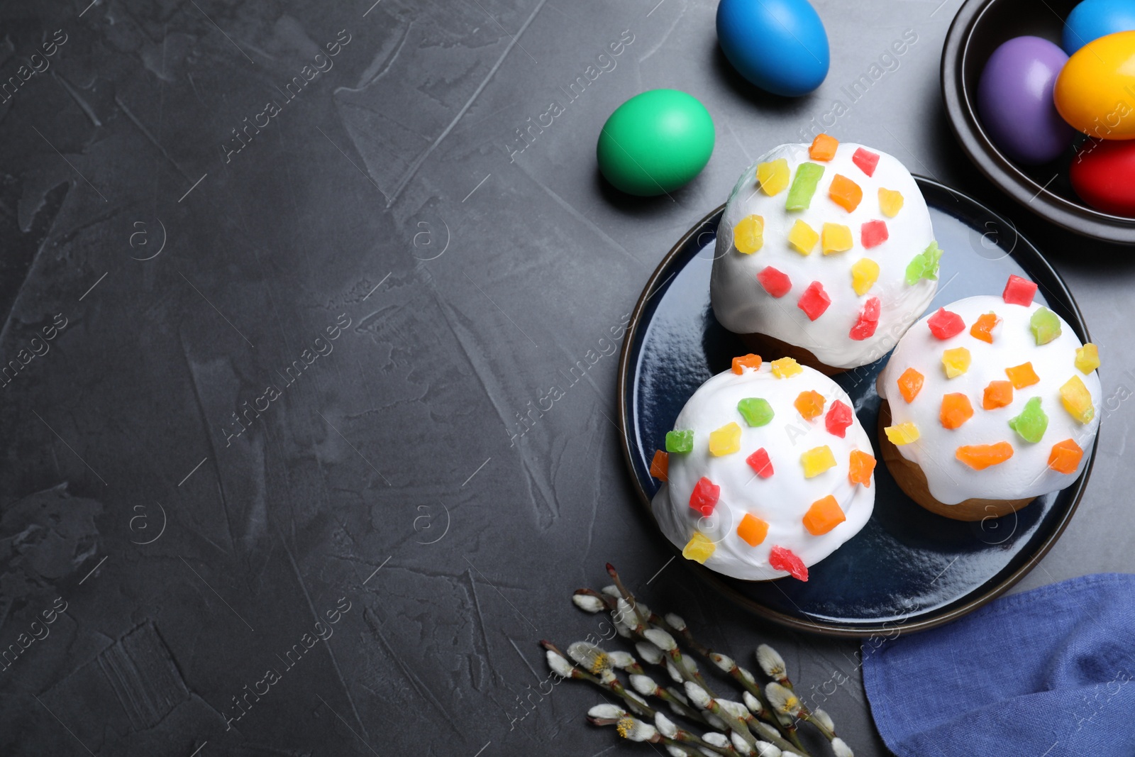 Photo of Flat lay composition with Easter cakes on dark grey table. Space for text