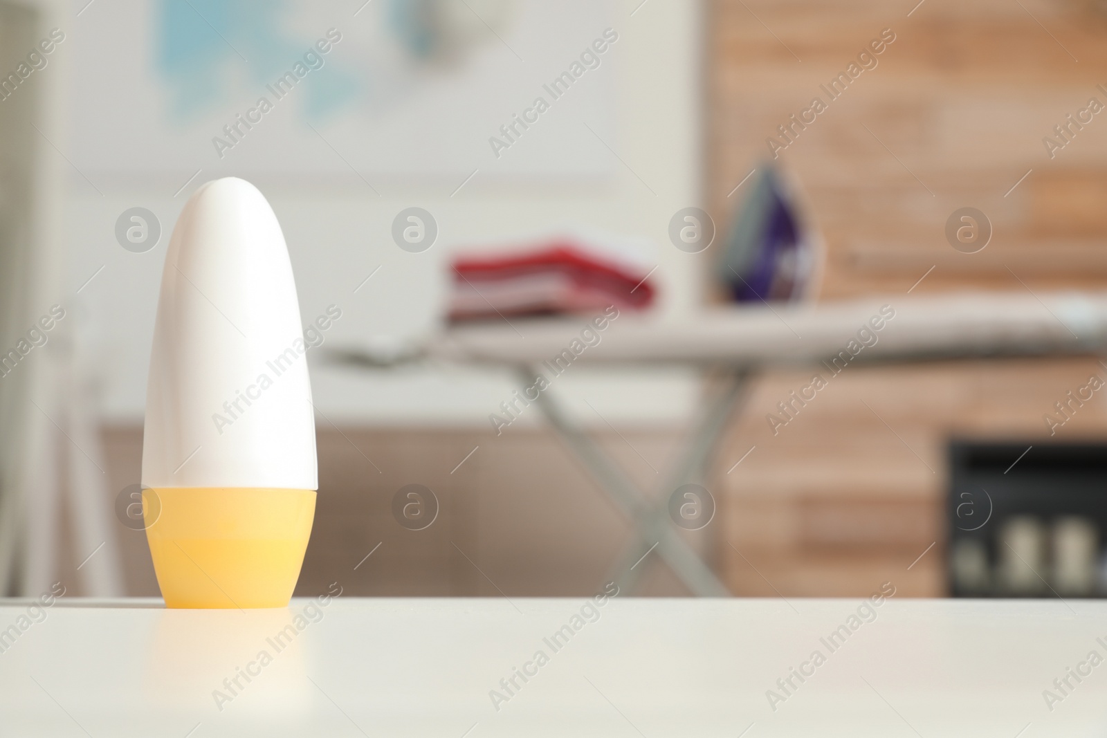 Photo of Roll-on deodorant on light table in room. Space for text