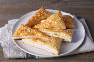 Delicious fresh puff pastries on wooden table