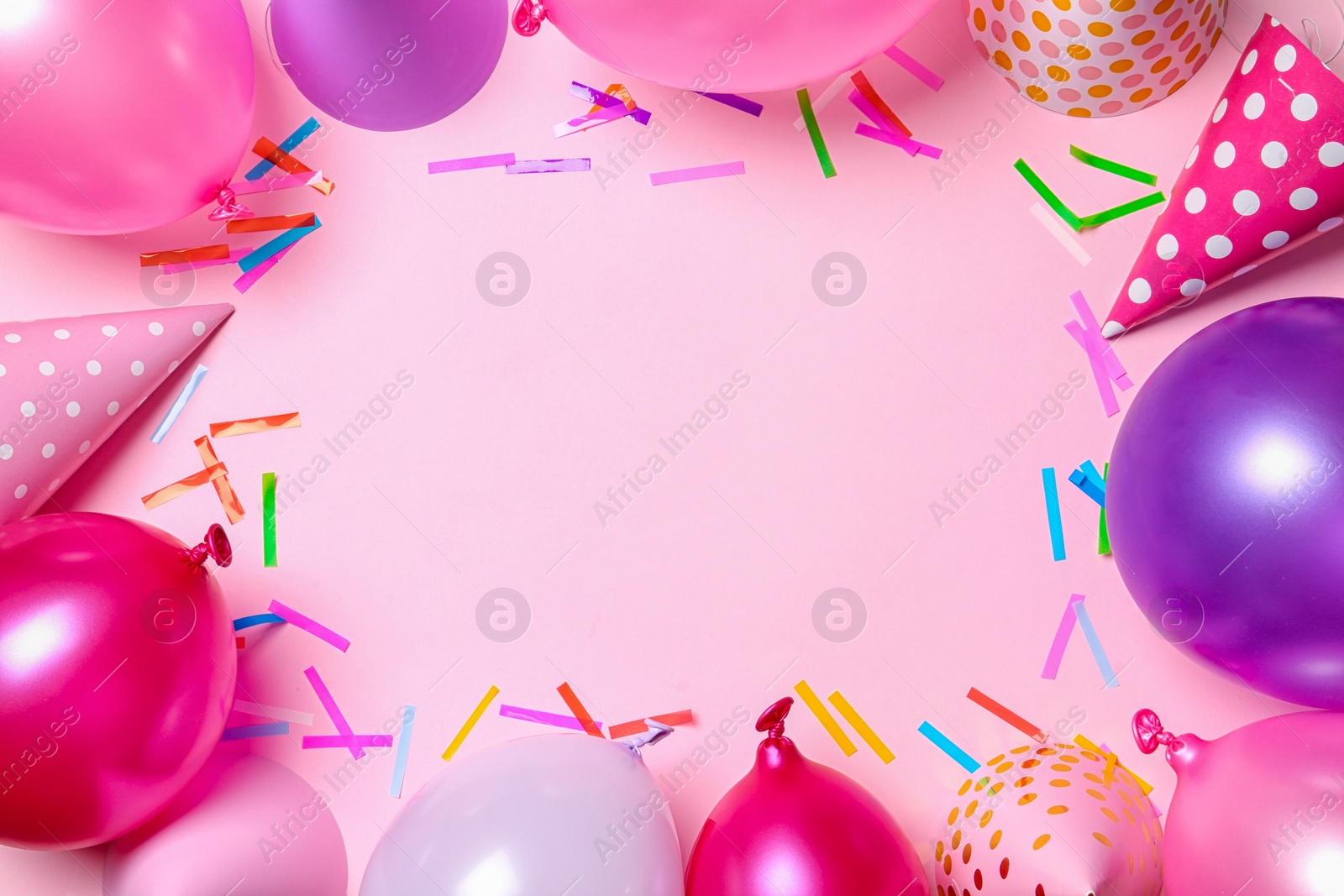 Photo of Frame made of balloons and party accessories on color background, top view with space for text