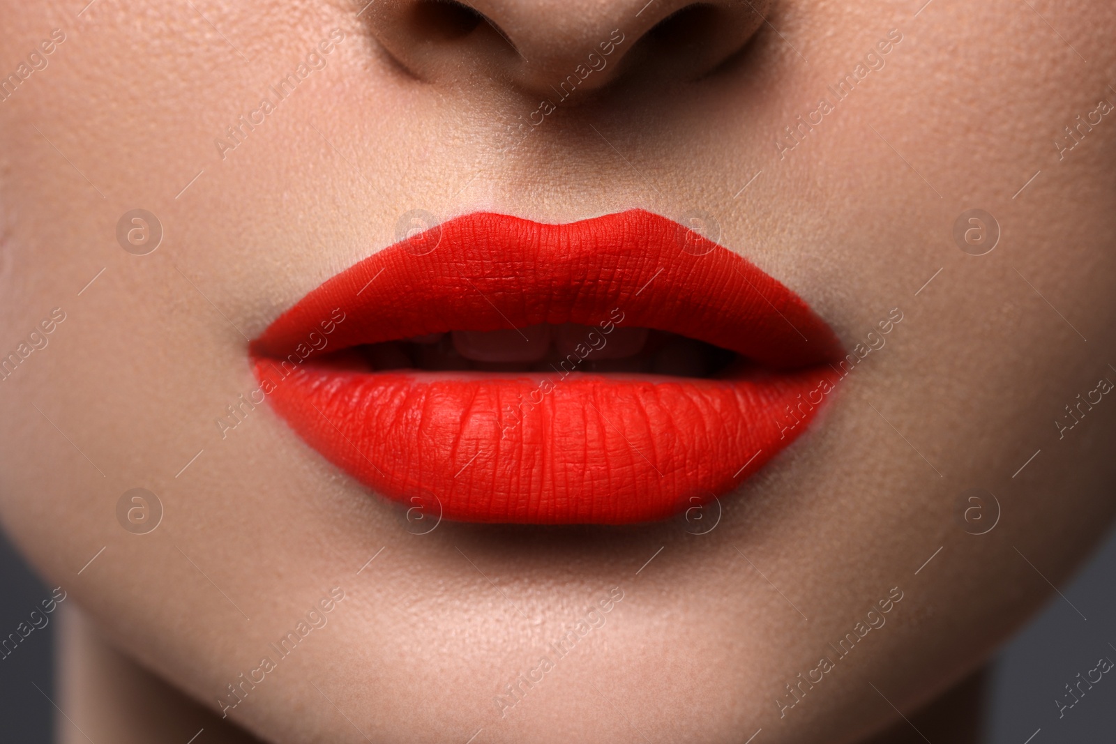 Photo of Young woman with beautiful red lips, closeup