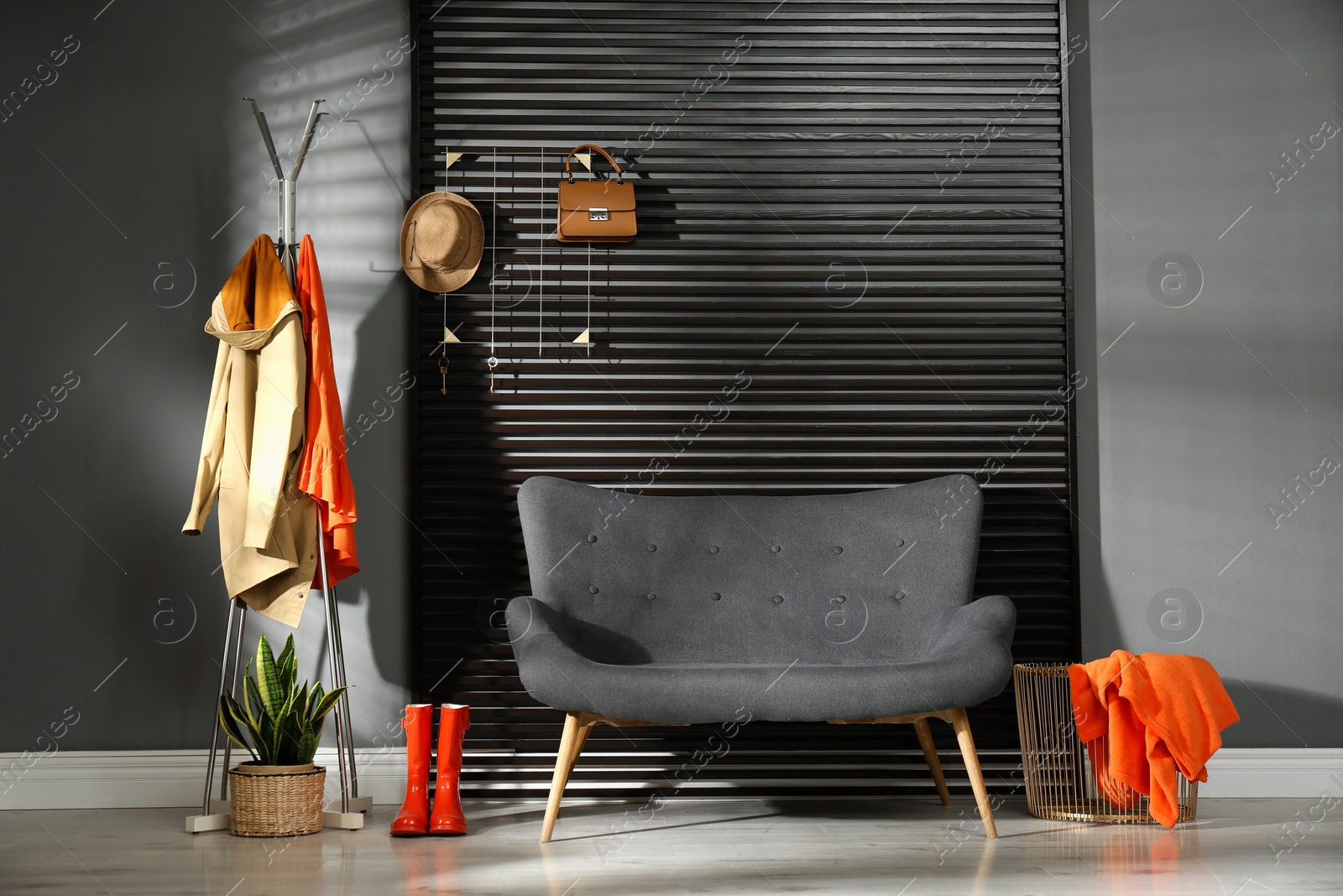 Photo of Hallway interior with sofa, clothes and accessories