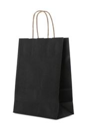 Photo of Blank black paper bag on white background. Space for design