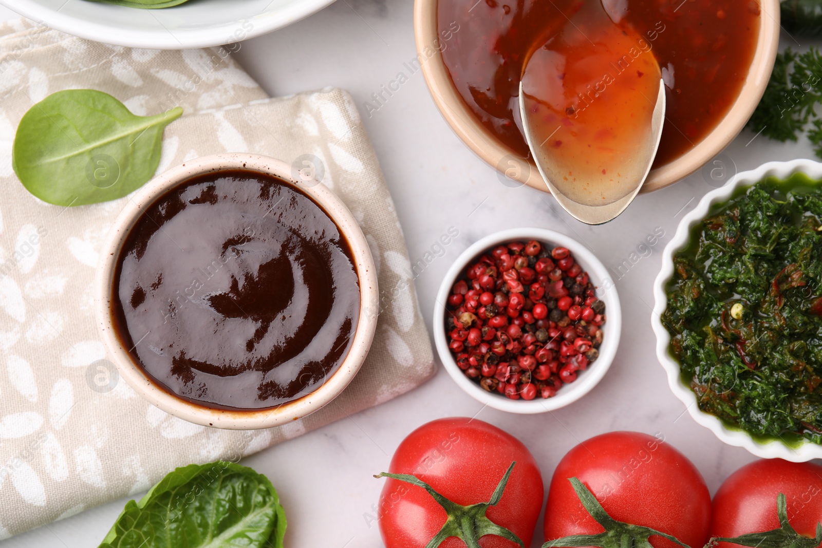 Photo of Different marinades and products on white marble table, flat lay