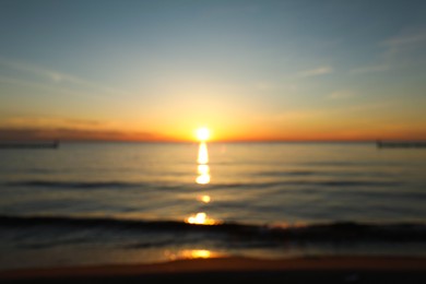 Blurred view of beautiful sea beach at sunset