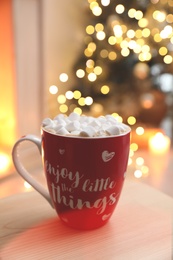 Photo of Hot drink with marshmallows in room. Magic Christmas atmosphere