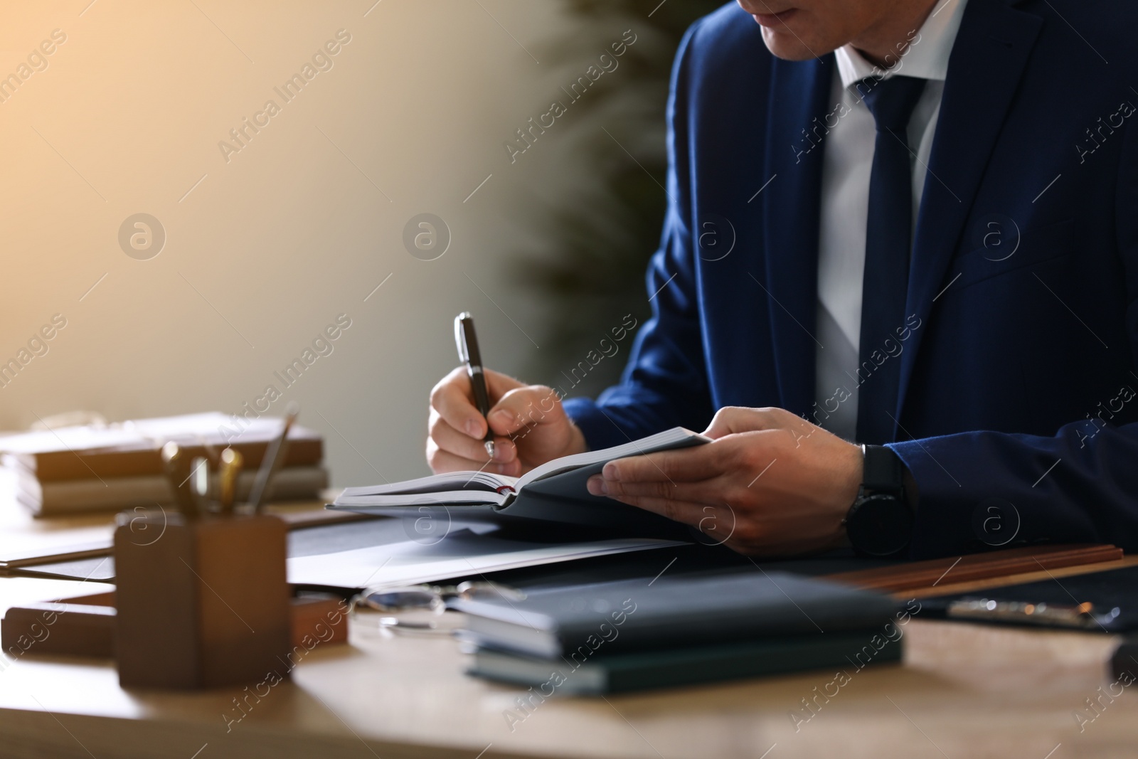 Photo of Male lawyer working at table in office, closeup