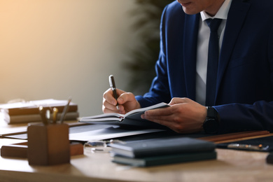 Photo of Male lawyer working at table in office, closeup