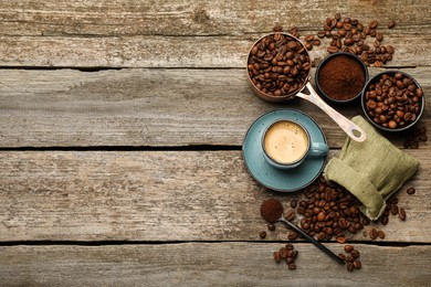 Coffee beans, powder and cup of drink on wooden table, flat lay. Space for text