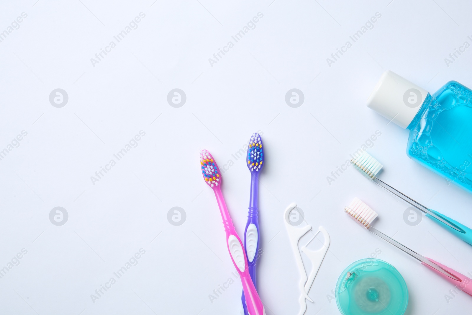 Photo of Flat lay composition with manual toothbrushes and oral hygiene products on white background