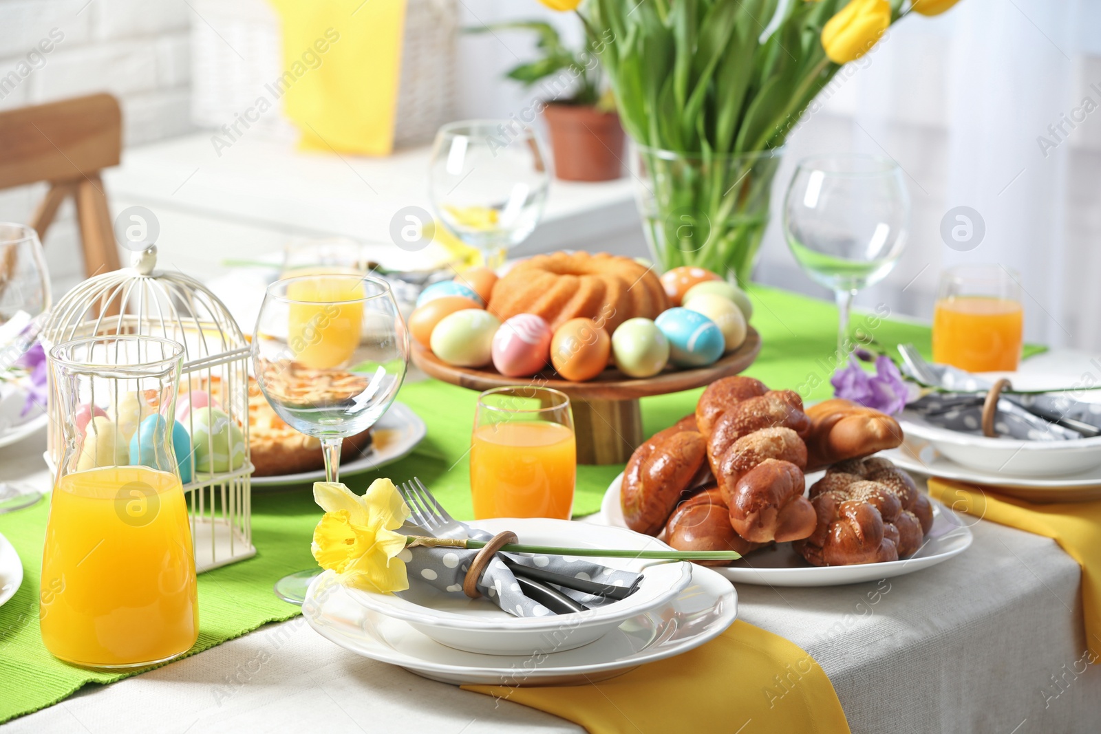 Photo of Festive Easter table setting with traditional meal at home