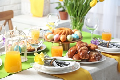 Photo of Festive Easter table setting with traditional meal at home