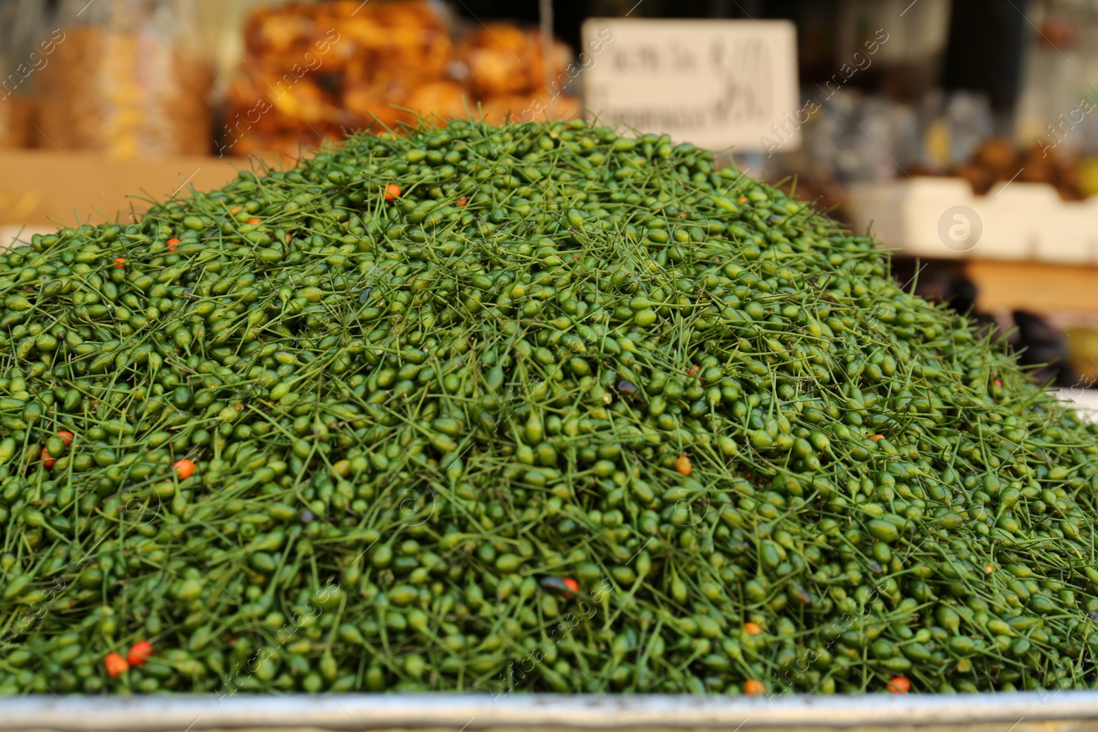 Photo of Heap of fresh delicious chiltepin on counter at market