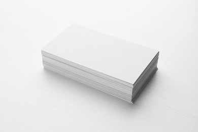 Photo of Stack of blank business cards on white table. Mockup for design