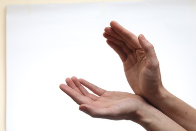 Photo of Man holding something in hands on white background, closeup