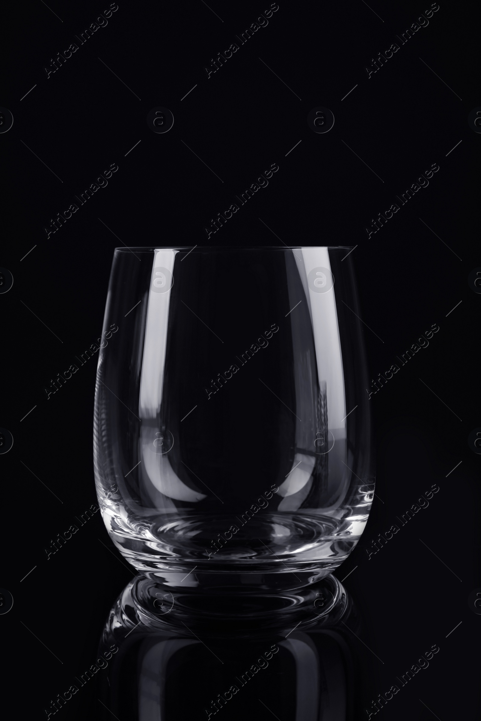 Photo of New clean empty glass on black background