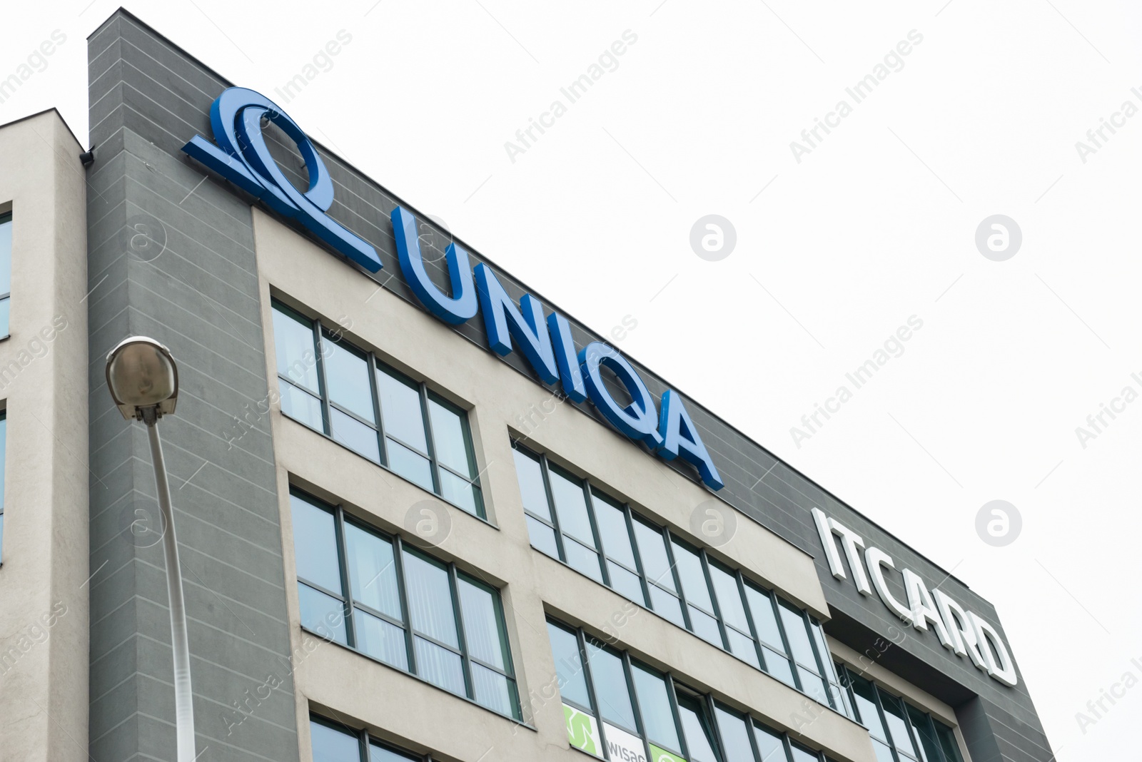 Photo of Warsaw, Poland - September 10, 2022: Building with modern Uniqa and Itcard logos