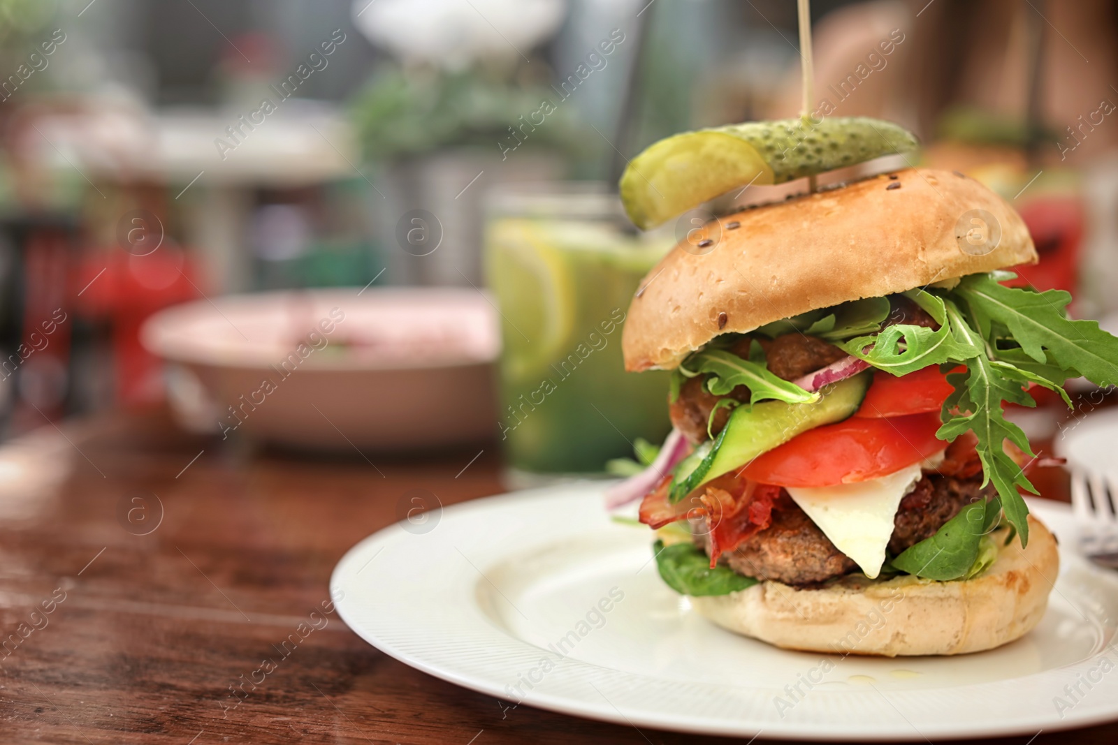 Photo of Plate with tasty fresh burger on table