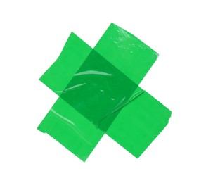 Photo of Crossed pieces of green adhesive tape on white background, top view