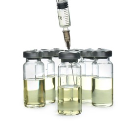 Photo of Syringe with vials of medicine on white background