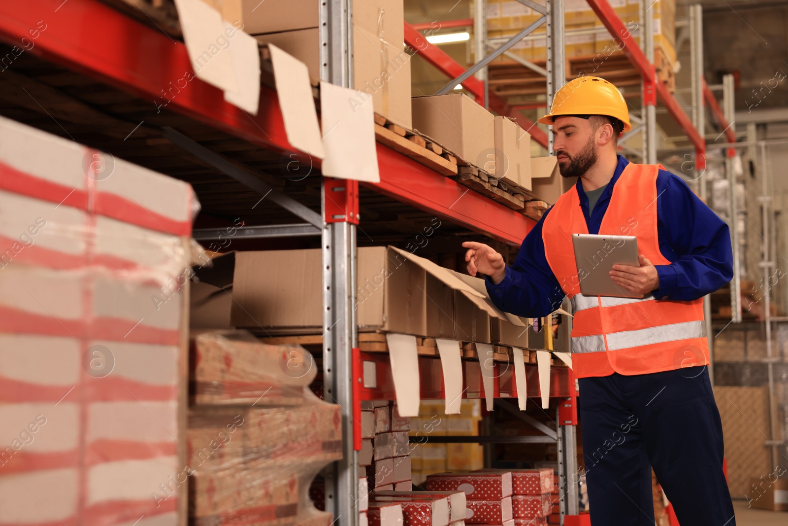 Image of Man with tablet working at warehouse. Logistics center