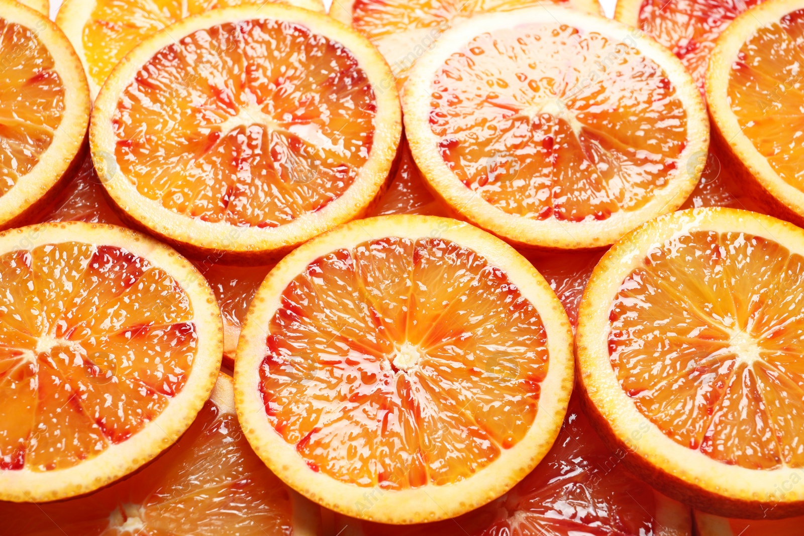 Photo of Juicy blood orange slices as background. Citrus fruit