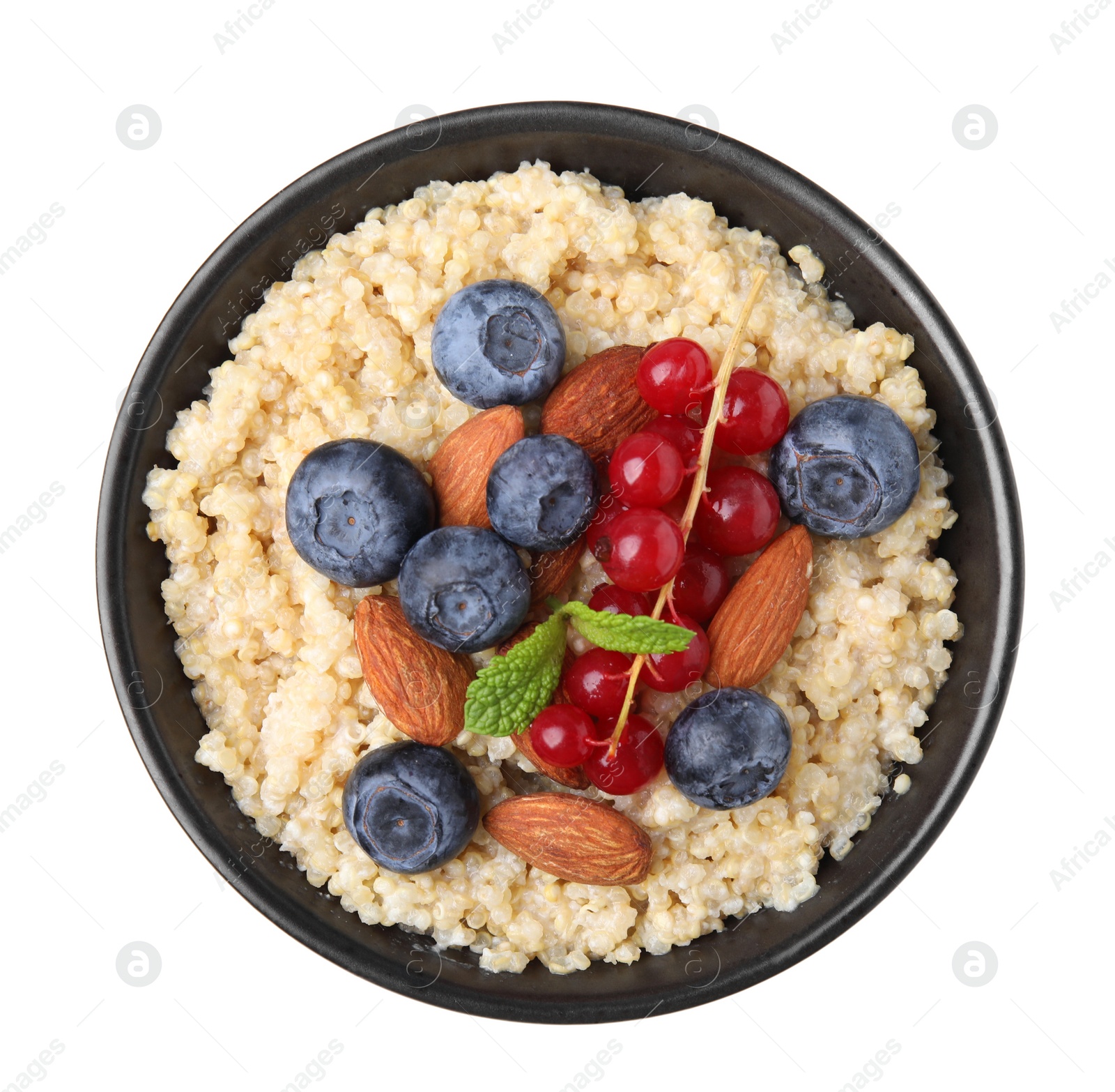 Photo of Bowl of delicious cooked quinoa with almonds, cranberries and blueberries isolated on white, top view
