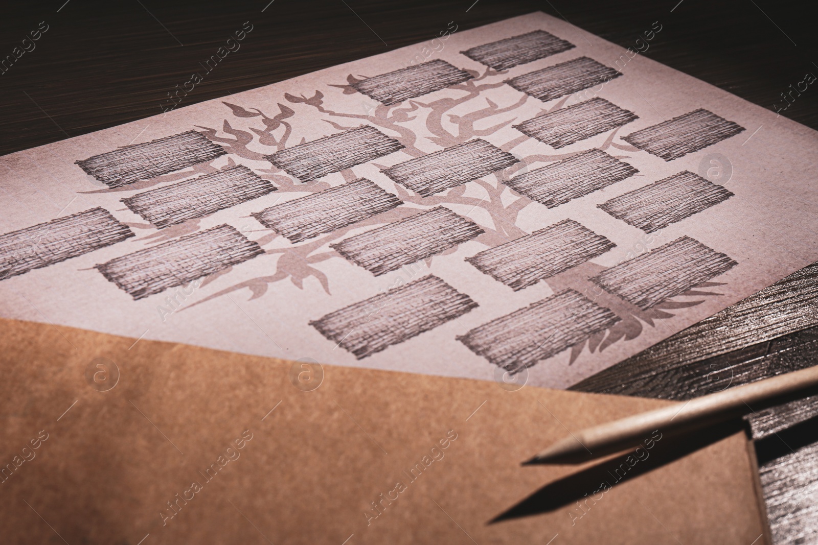 Photo of Blank family tree, notebook and pencil on table, closeup