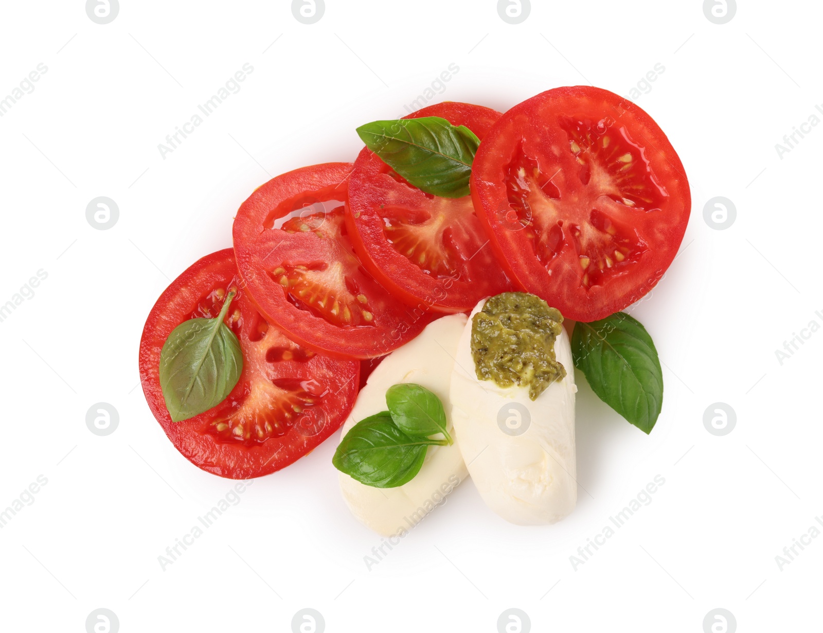 Photo of Delicious Caprese salad with tomatoes, mozzarella cheese, basil leaves and pesto sauce isolated on white, top view