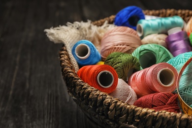 Photo of Basket with color sewing threads, closeup