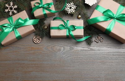 Photo of Flat lay composition with gift boxes and Christmas decorations on wooden table, space for text
