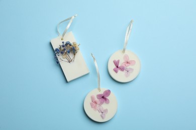 Beautiful scented sachets on light blue background