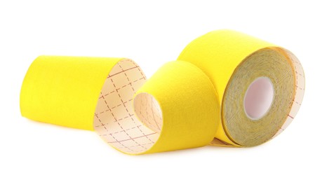 Yellow kinesio tape in roll on white background