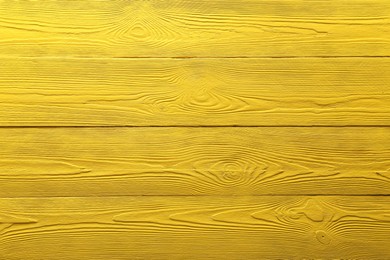 Photo of Texture of yellow wooden surface as background, top view