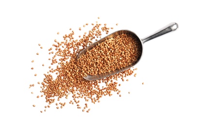 Photo of Scoop with uncooked buckwheat on white background, top view