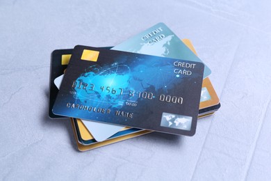 Many credit cards on grey textured table