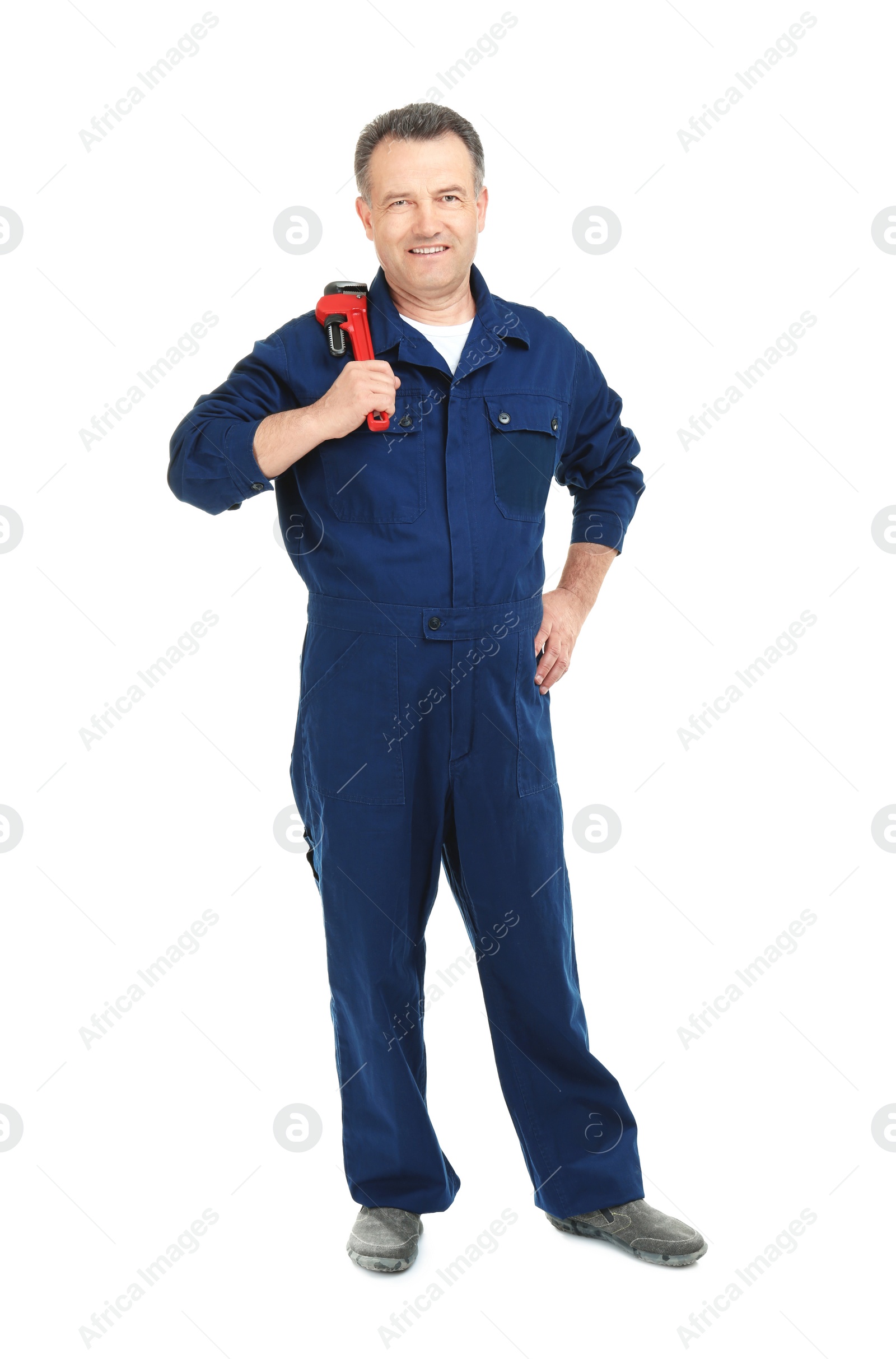 Photo of Mature plumber with pipe wrench on white background