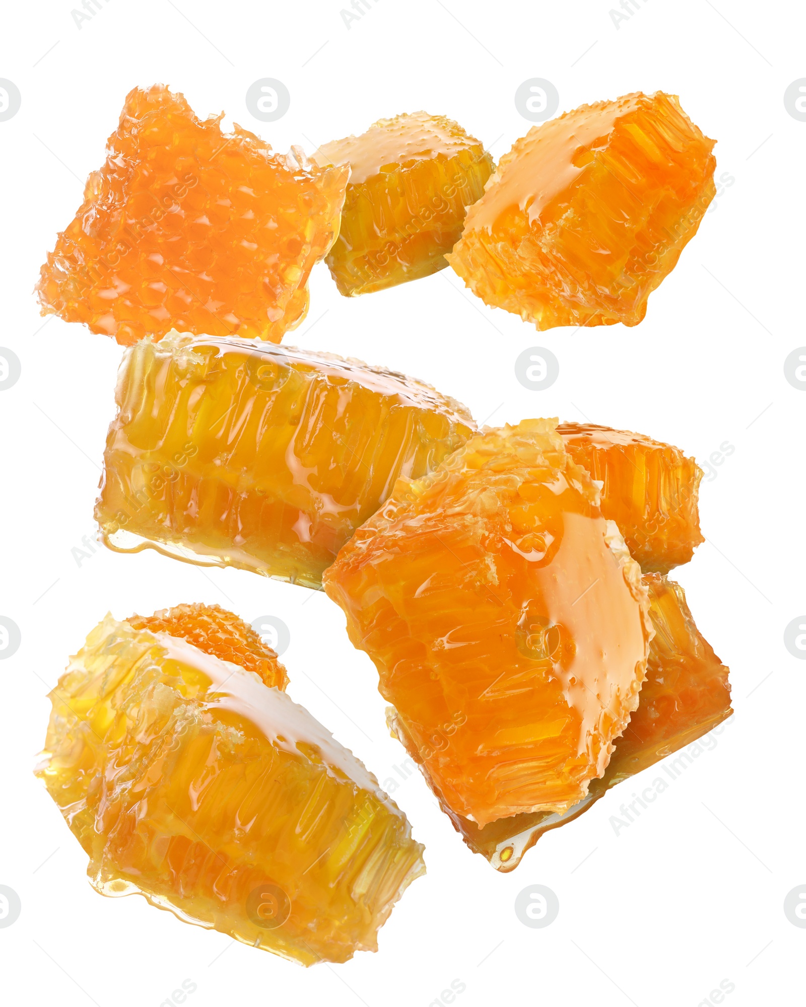 Image of Pieces of honeycomb falling on white background