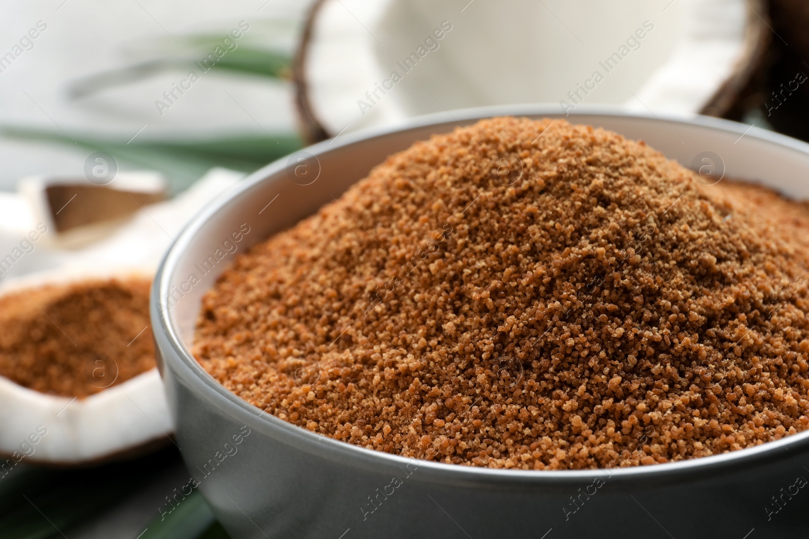 Photo of Natural coconut sugar in ceramic bowl, closeup