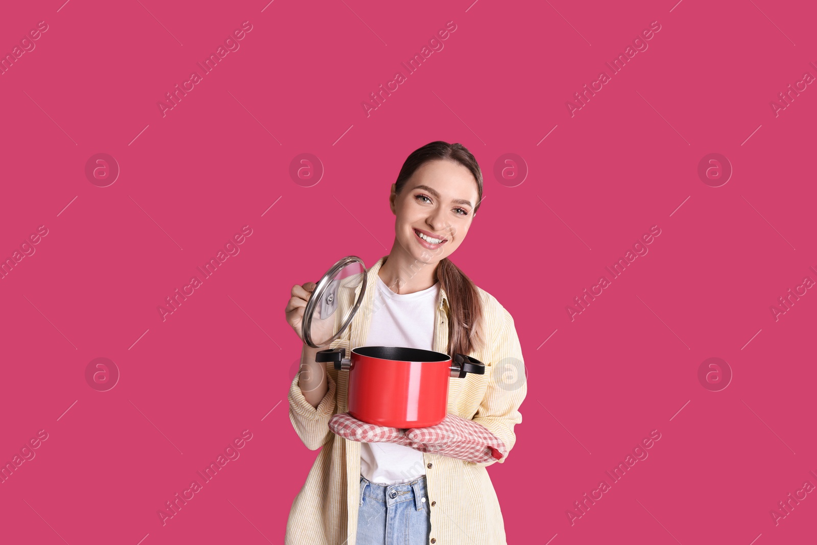 Photo of Happy woman with pot on crimson background
